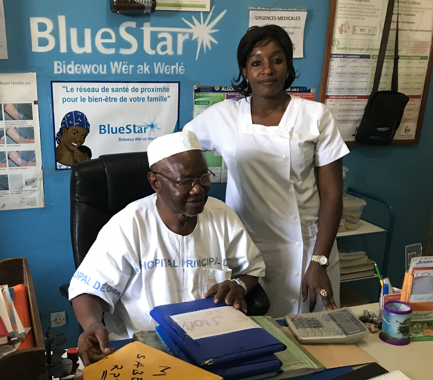 Beauger Tamba and Fatou Samb behind a desk at SABES paramedical health facility